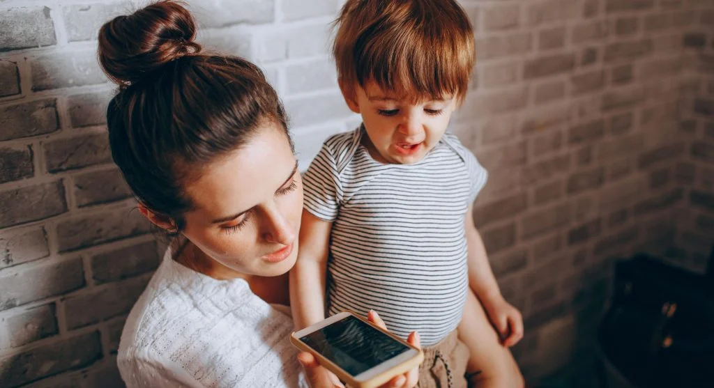 Parent taking back a phone after clearly naming the end of a child’s turn