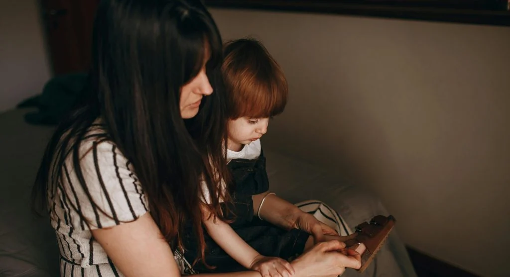 parent guiding child in calm behavior