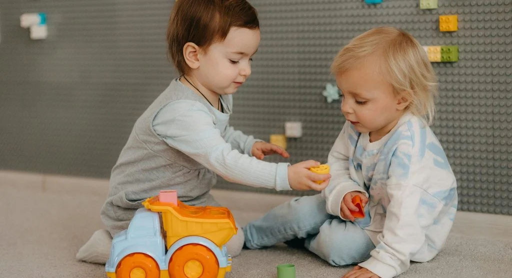 children sharing toys during playtime