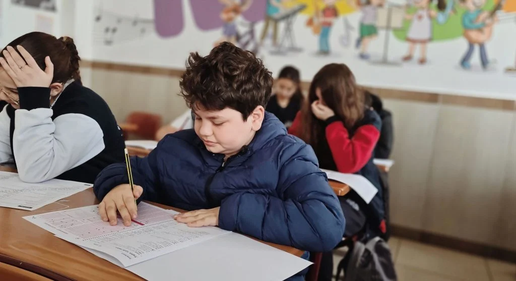 Child continuing a starter sentence during writing practice at home