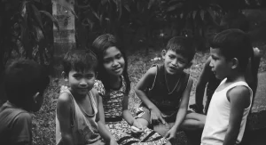 Child staying quiet near a parent in a group setting