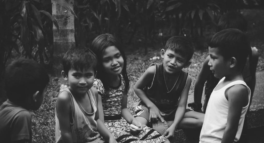 Child staying quiet near a parent in a group setting
