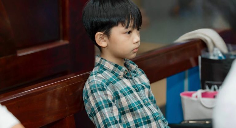 kid waiting calmly alone