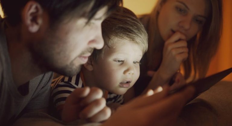family using devices together