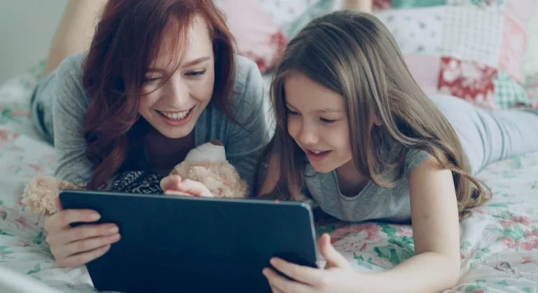 Parent preparing a visible next activity for a child after screen time at home
