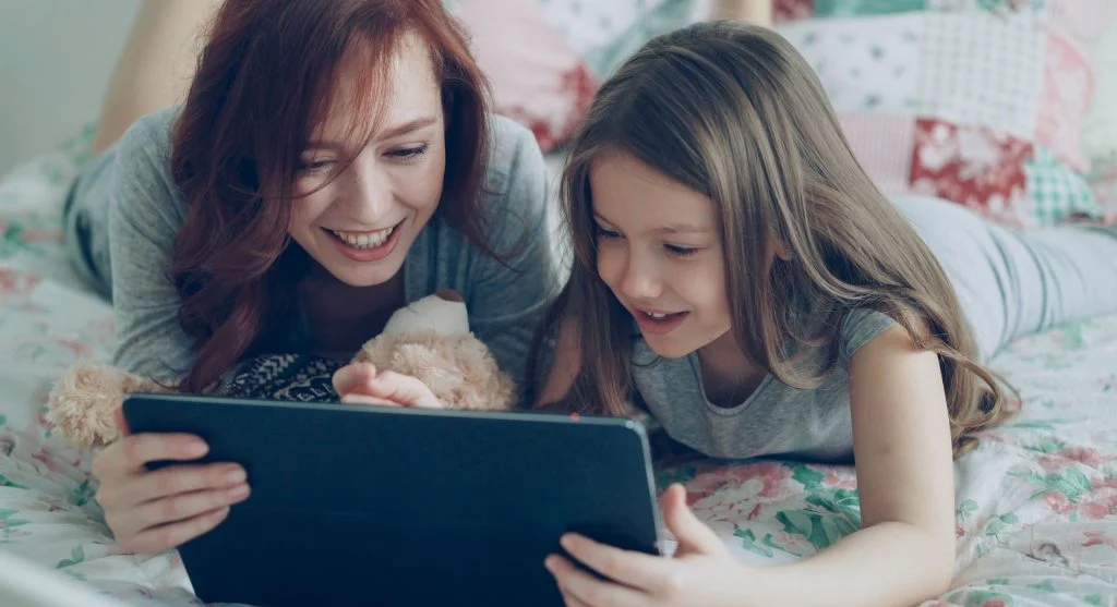 Parent preparing a visible next activity for a child after screen time at home