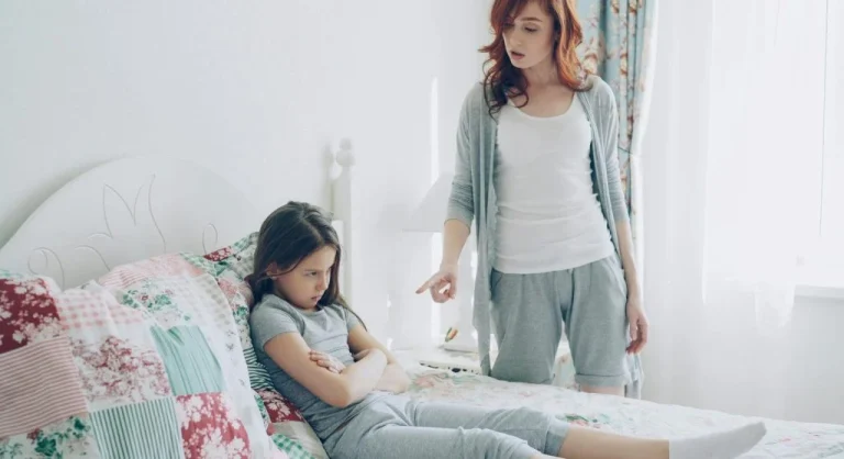 parent calmly correcting child at home