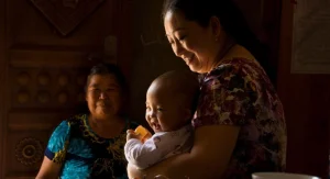 Child taking on a bigger role in a family tradition at home