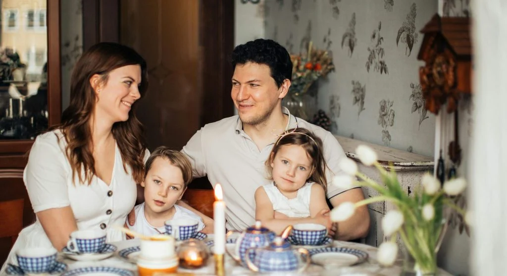 Family taking part in a tradition together with small shared roles at home