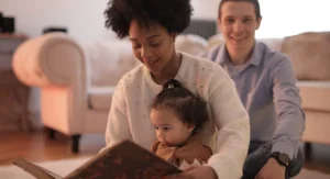 Child explaining something learned from reading while a parent listens at home