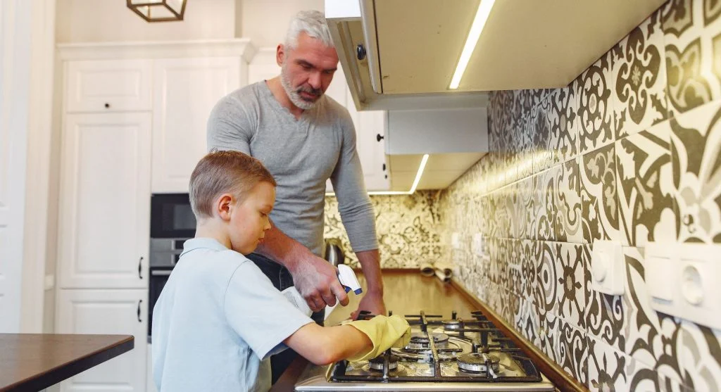 Parent calmly guiding cleanup by naming where items belong first