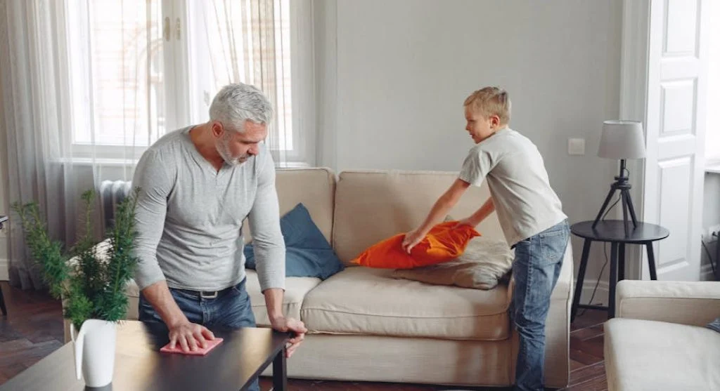 child cleaning playroom toys
