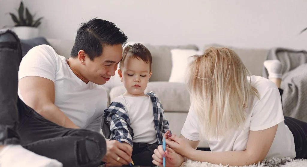 Parent and child talking naturally while drawing together at home