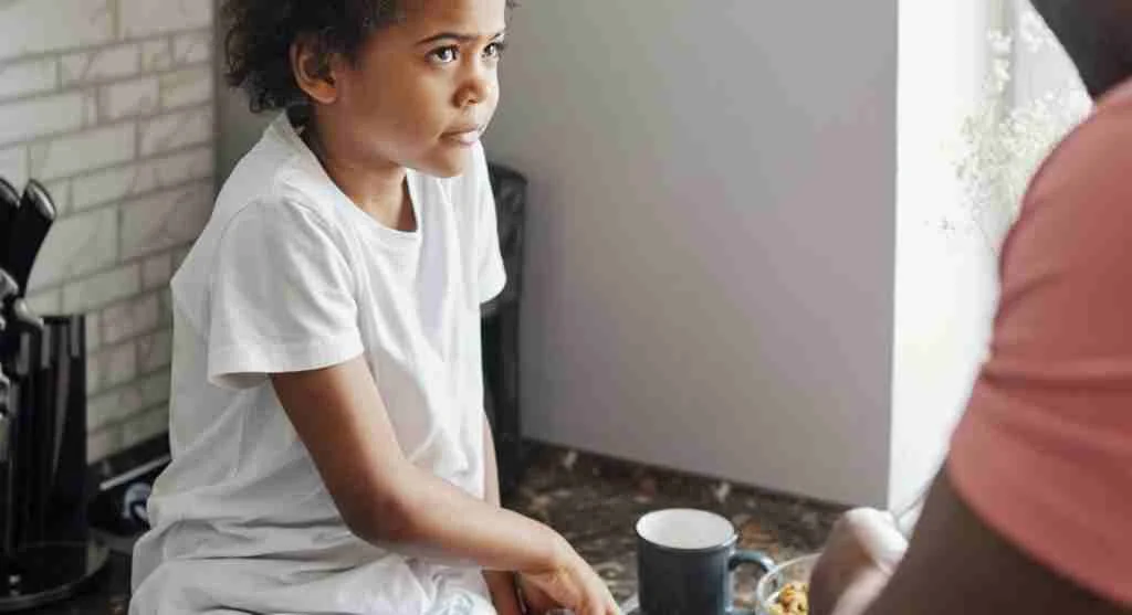 Parent helping a child explain what felt unfair during a family conversation