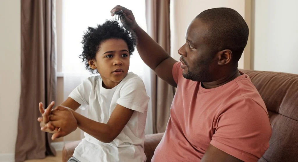 Parent staying calm while a child reacts defensively after an awkward moment