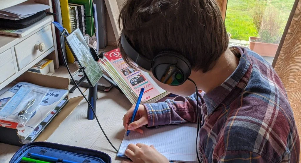 Child focusing on one visible worksheet problem at a time during home learning