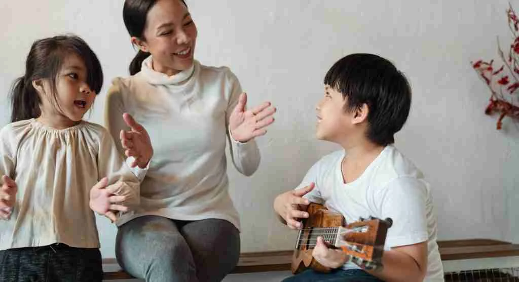 Child smiling when a familiar song begins during a family tradition