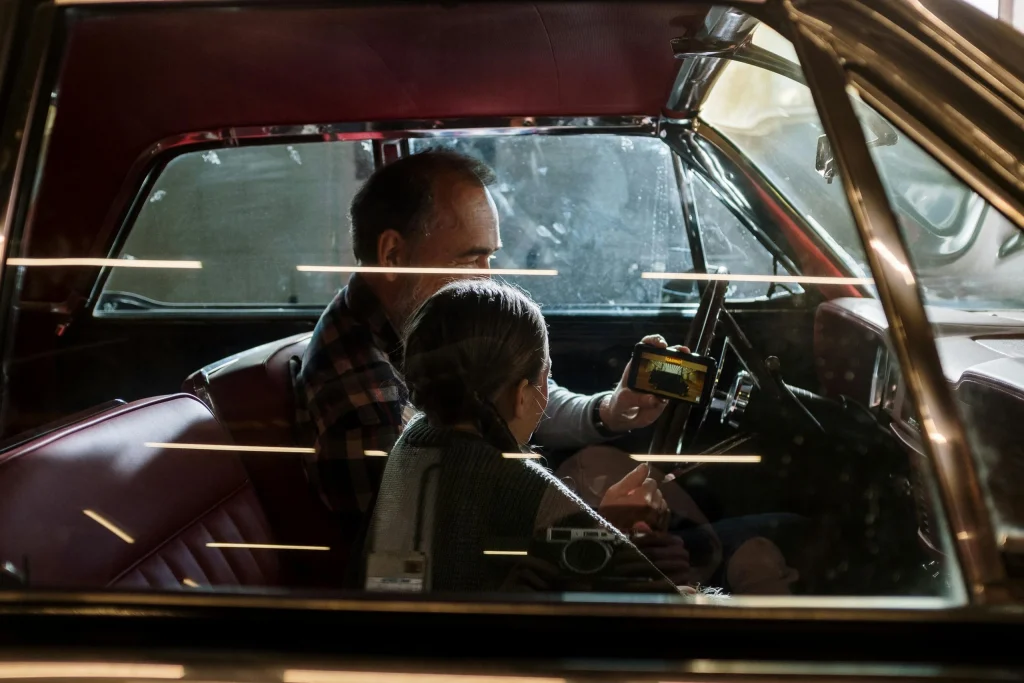 Parent sharing a familiar ride home ritual with a child after an outing