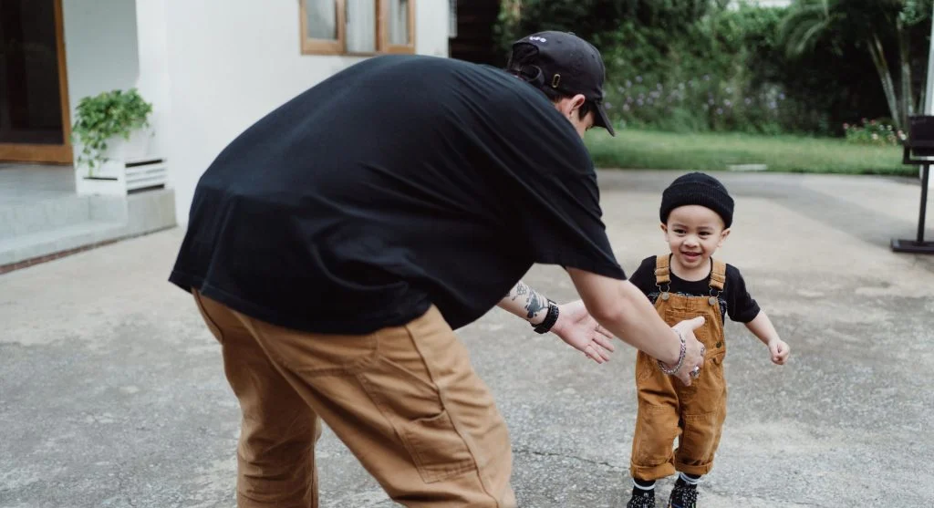 Parent smiling while a child responds literally to a casual phrase