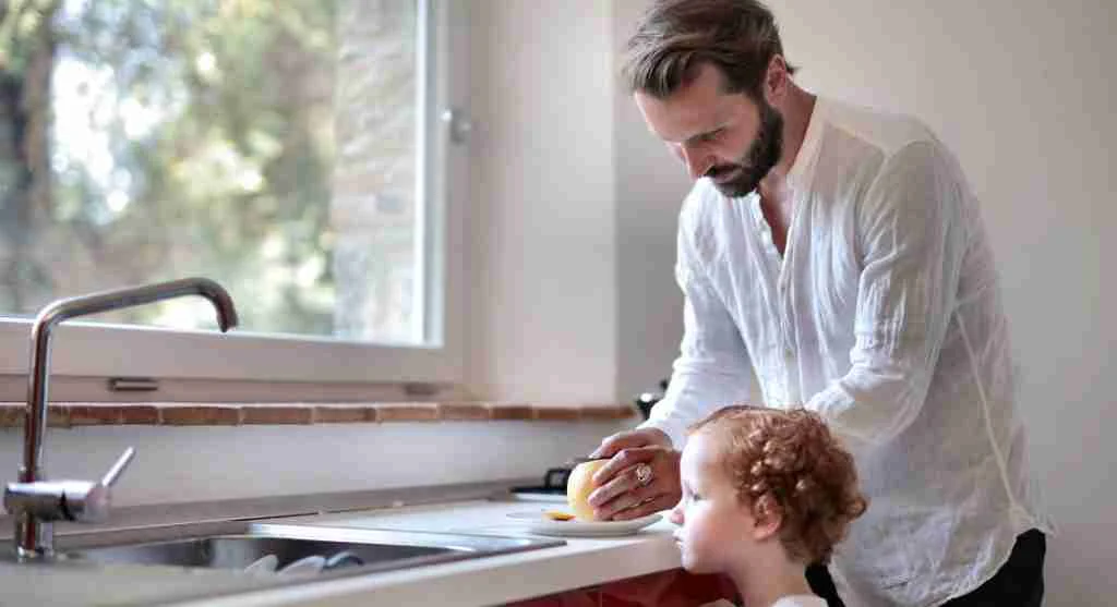 Parent giving a child the next routine item before shared screen time ends