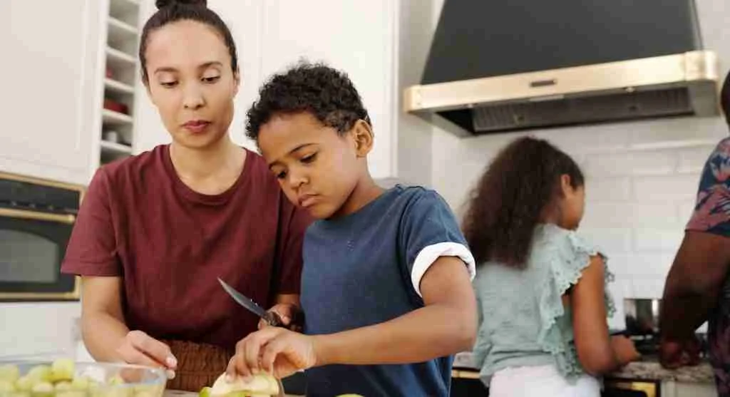 Family watching a child complete a familiar job that begins a tradition