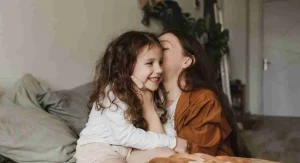 Child trying to whisper a private comment to a parent in public