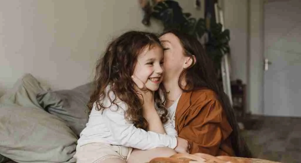 Child trying to whisper a private comment to a parent in public