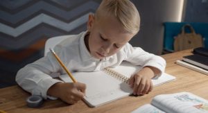 kid studying at desk with books
