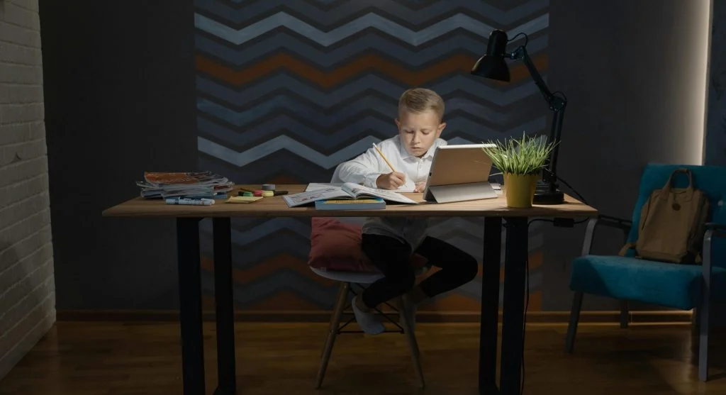 child studying at home table