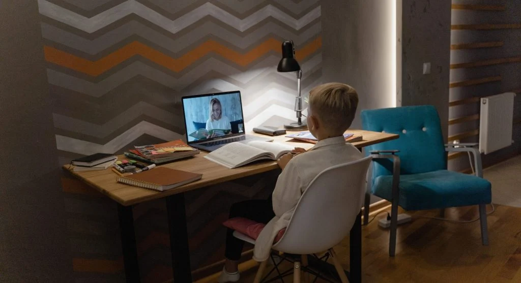Child repeating homework instructions while preparing to begin work at home