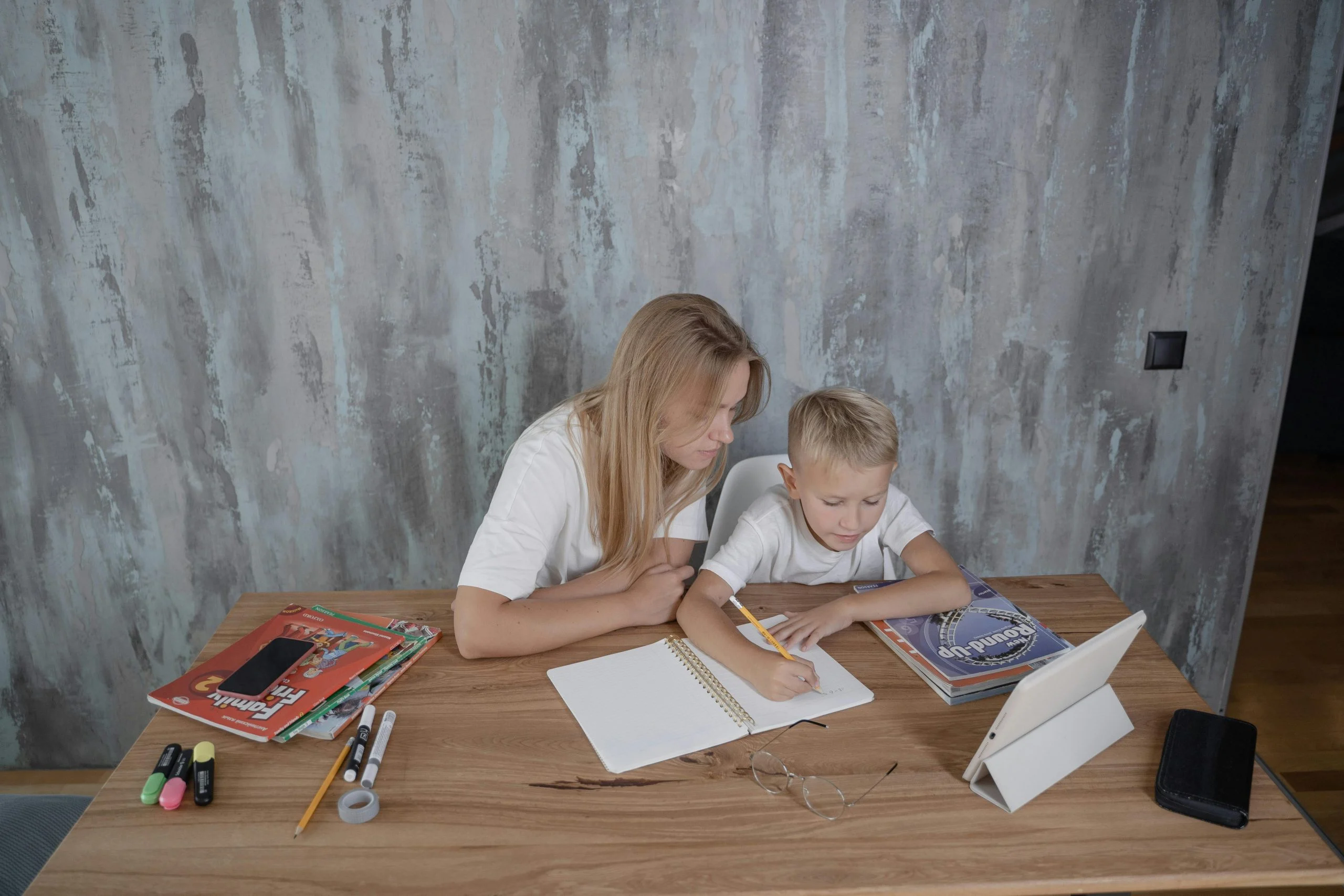 Child working through a difficult task while a parent calmly waits nearby