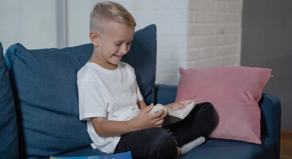 smiling kid reading a book