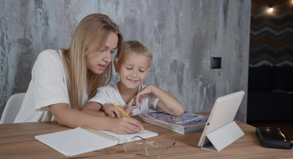 Parent pointing out a repeated spelling pattern before practice at home