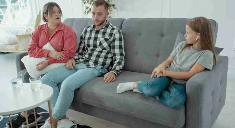 Parent listening calmly while a child explains a mistake at home