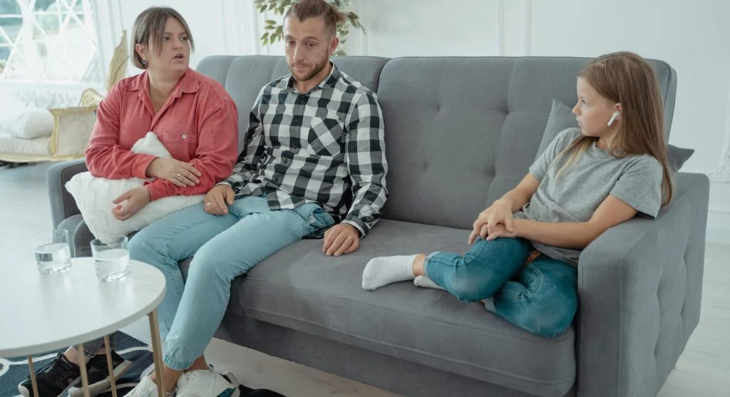 Child admitting a small problem while a parent listens calmly at home