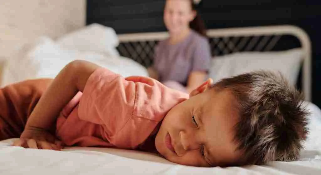 Child noticing a ready turned-down bed before changing into pajamas