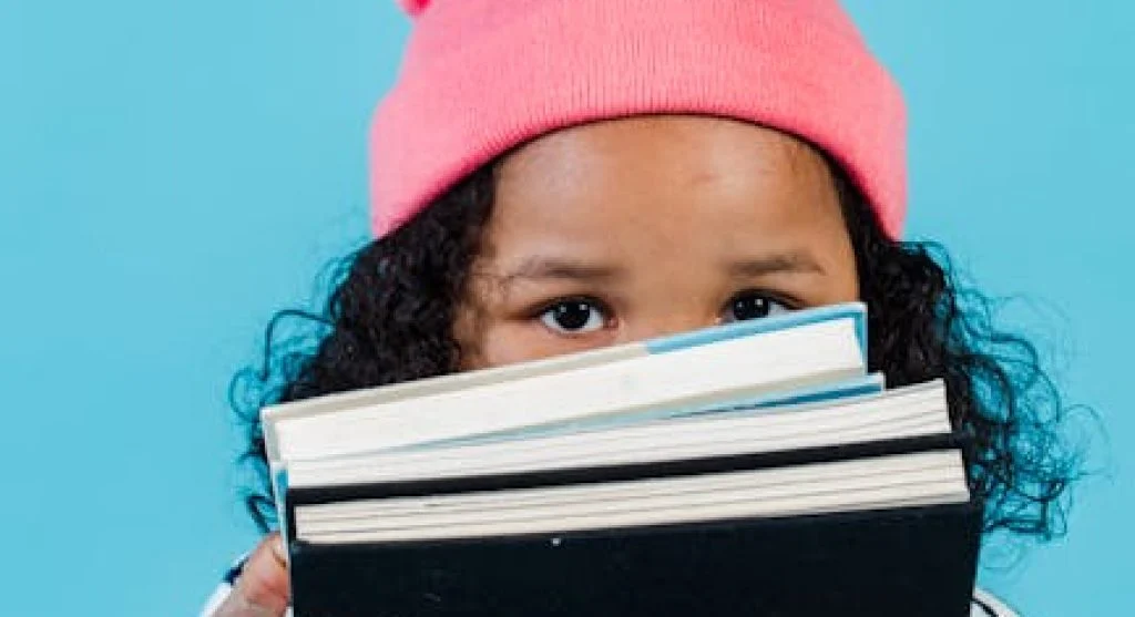 kid reading book happily
