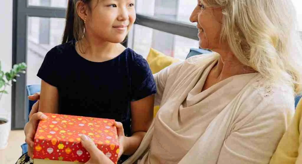 Child receiving a real-world item before handing over a shared device