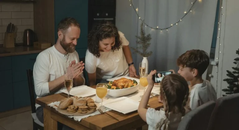 Family putting devices into a basket before a phone-free dinner at home
