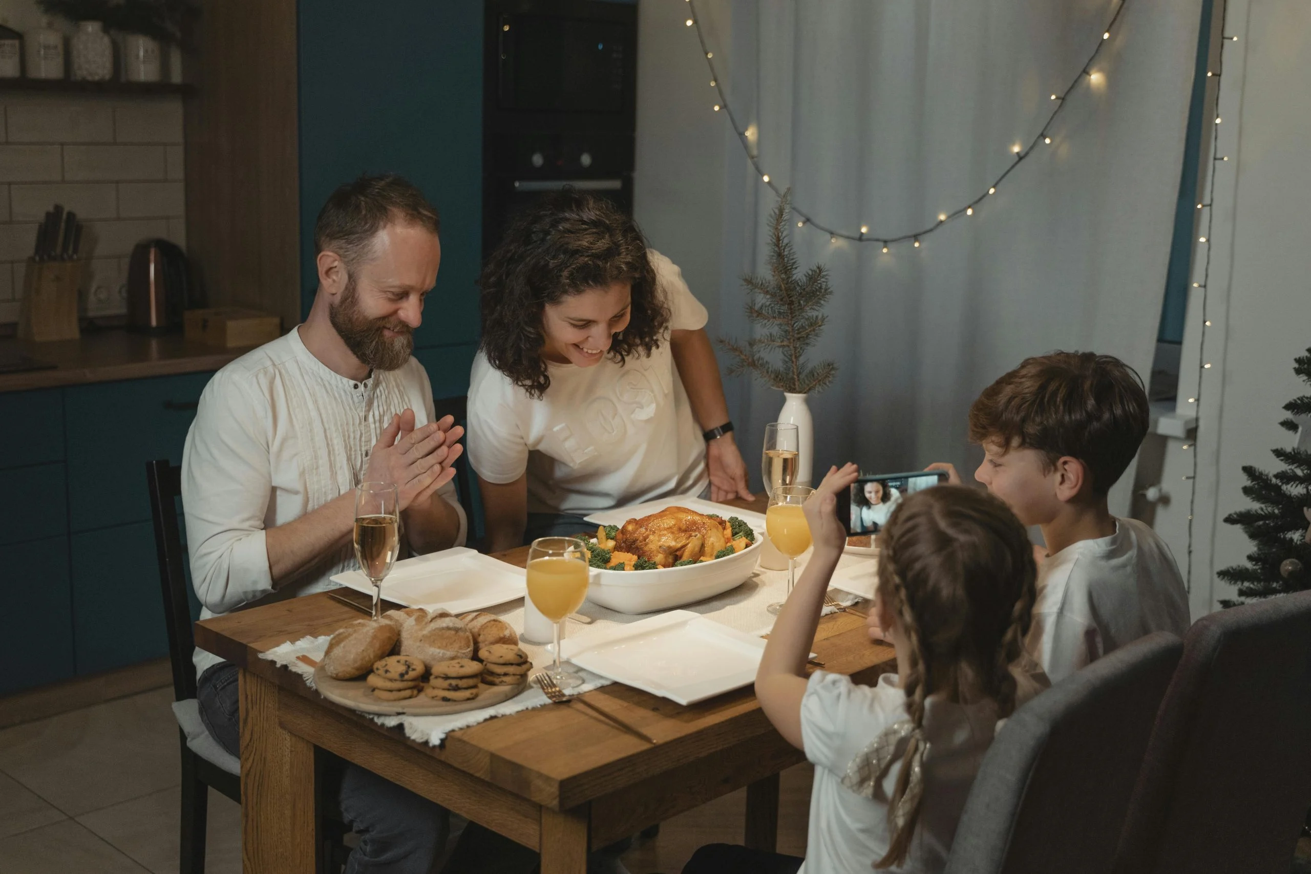 Family putting devices into a basket before a phone-free dinner at home