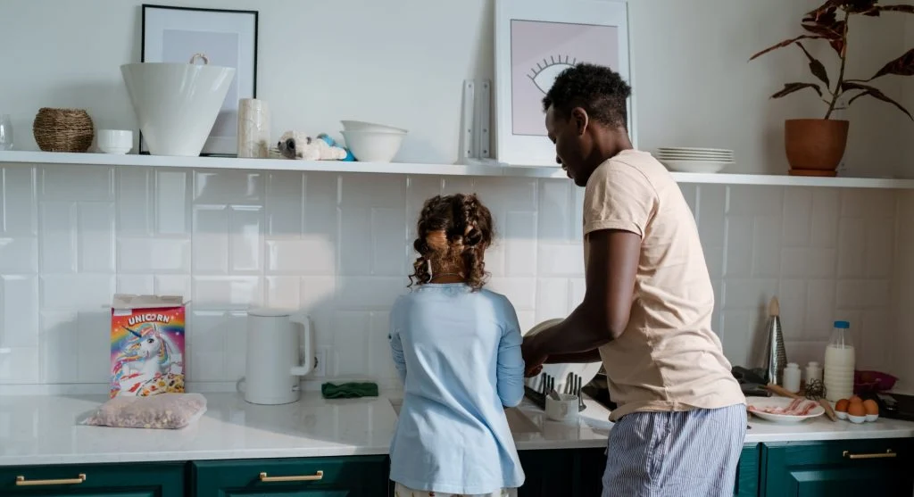 Parent giving a short practical routine preview during a family transition