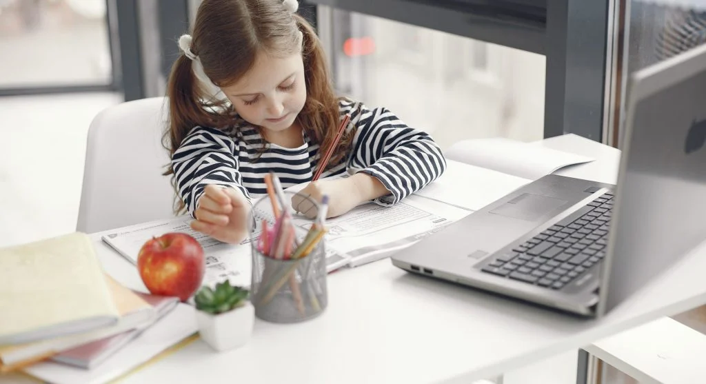 kid doing homework with pencil