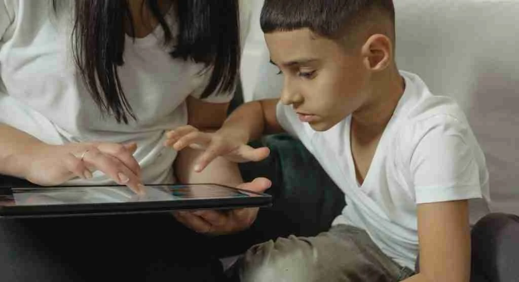 Parent calmly taking a tablet after the child returns it to the home screen