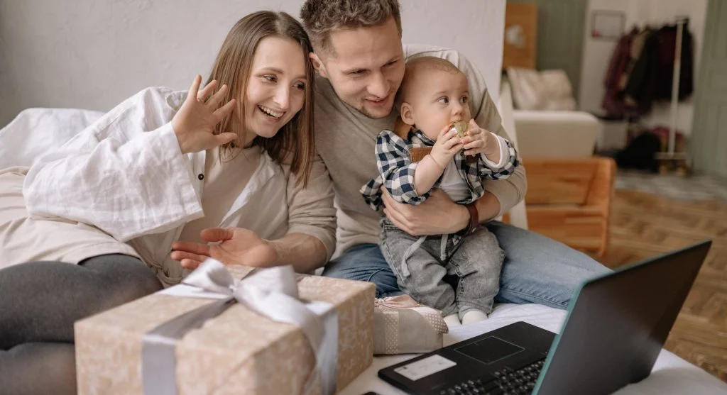 Child waving during the goodbye part of a family video call