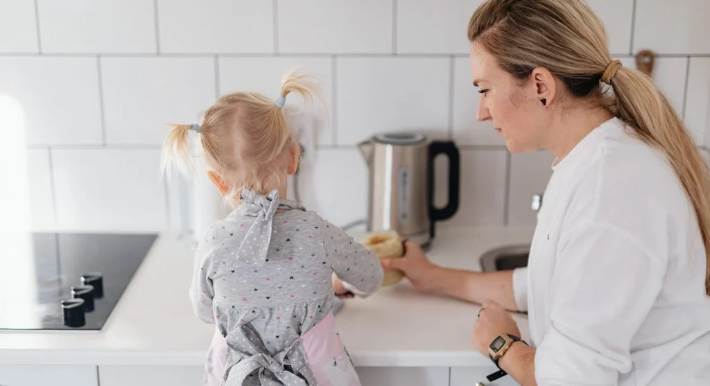 Child helping with a larger role during a familiar family tradition