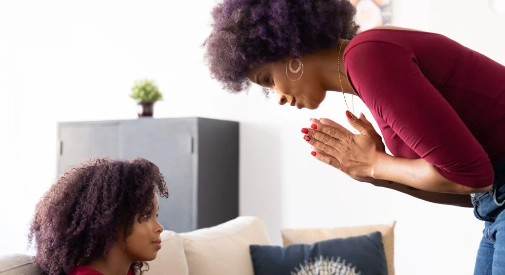 Parent calmly acknowledging a difficult moment with a child at home