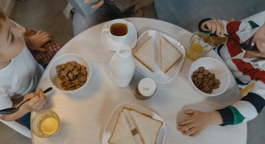 happy kids eating breakfast together