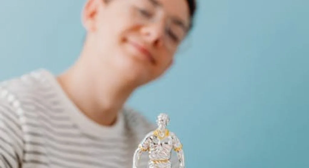 smiling kid holding reward trophy