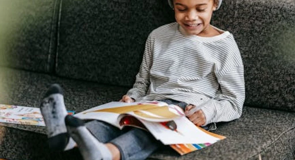 smiling kid reading book