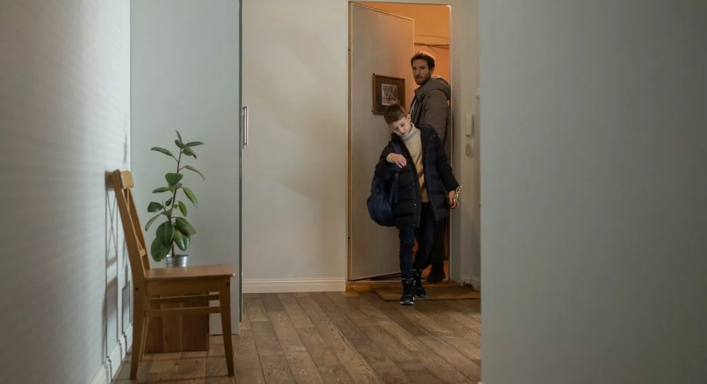 Child using one ready spot near the door to finish getting ready to leave